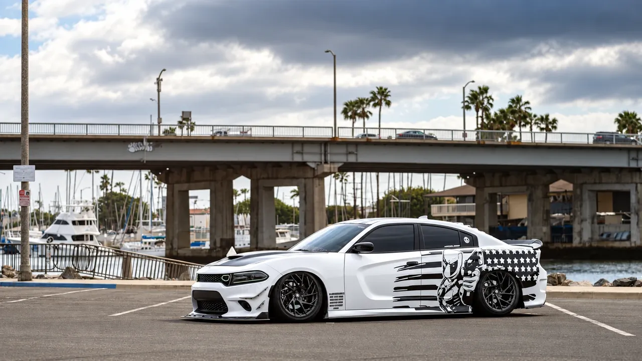 White Dodge Charger with a black-and-white flag graphic and black wheels