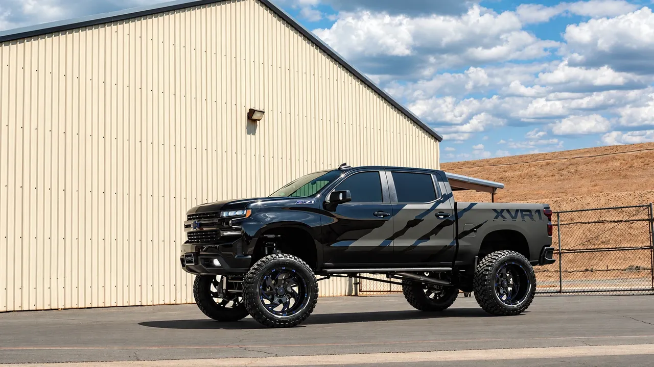 Lifted black Chevrolet Silverado on black off-road wheels