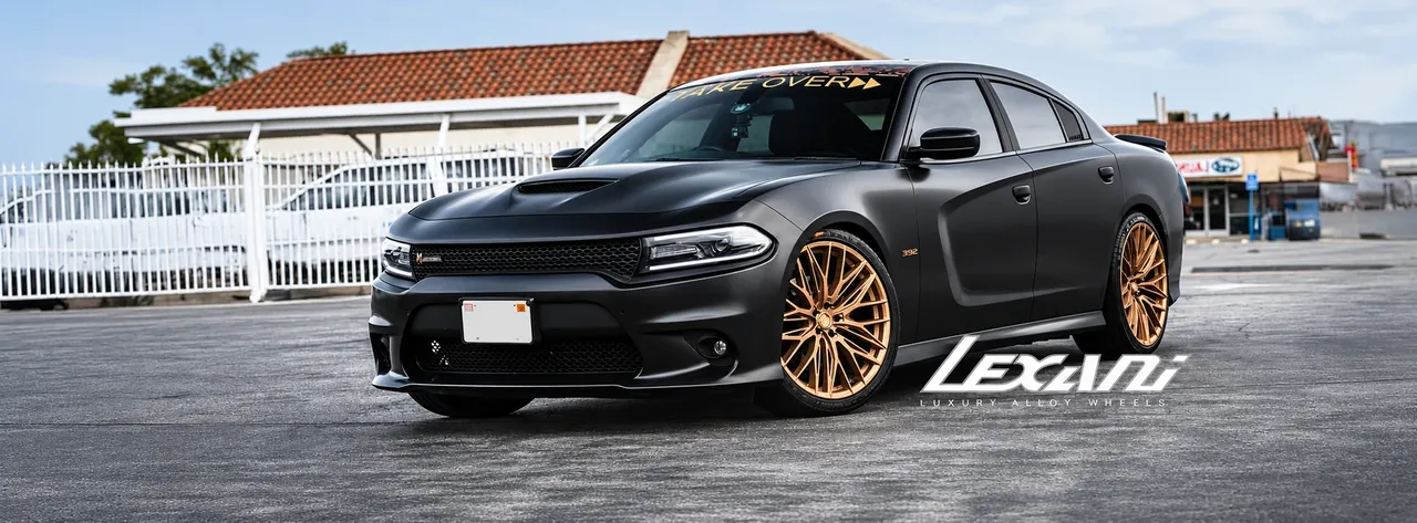 Matte black Dodge Charger on gold mesh wheels with Lexani branding