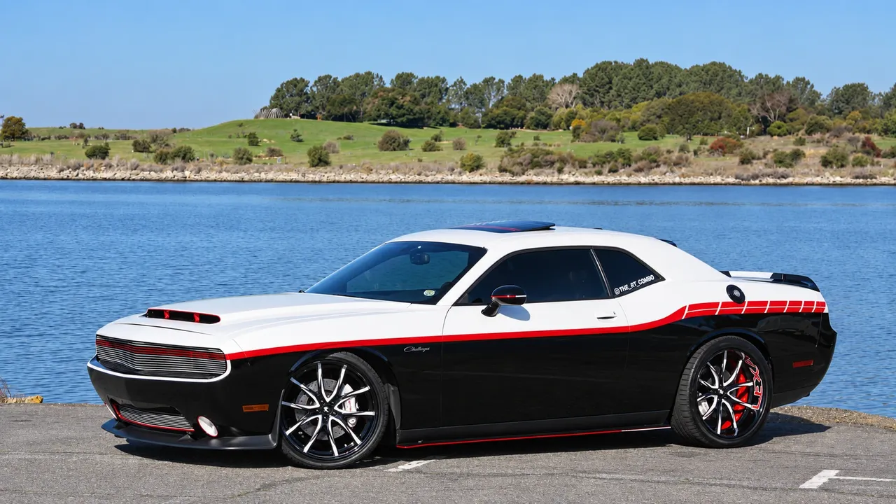 Dodge Challenger in a white, red and black two-tone wrap beside the water