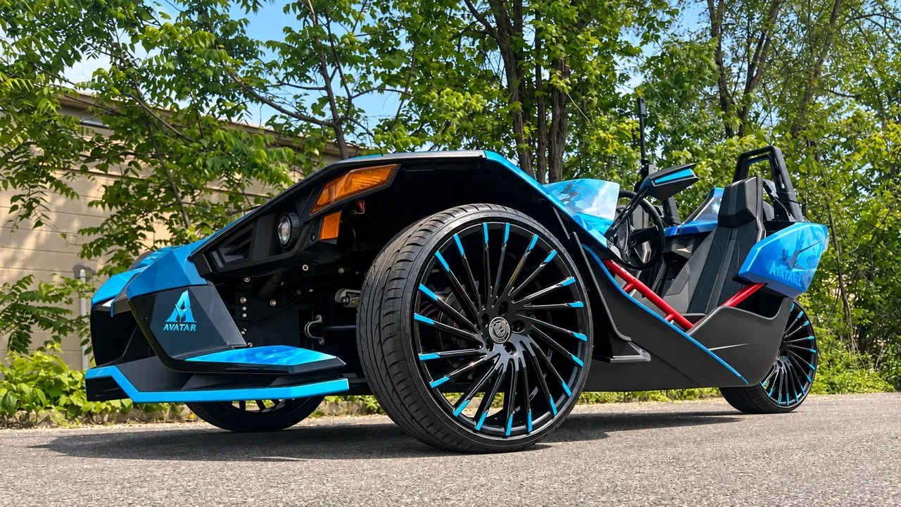 Black and blue Polaris Slingshot on large black wheels with blue accents
