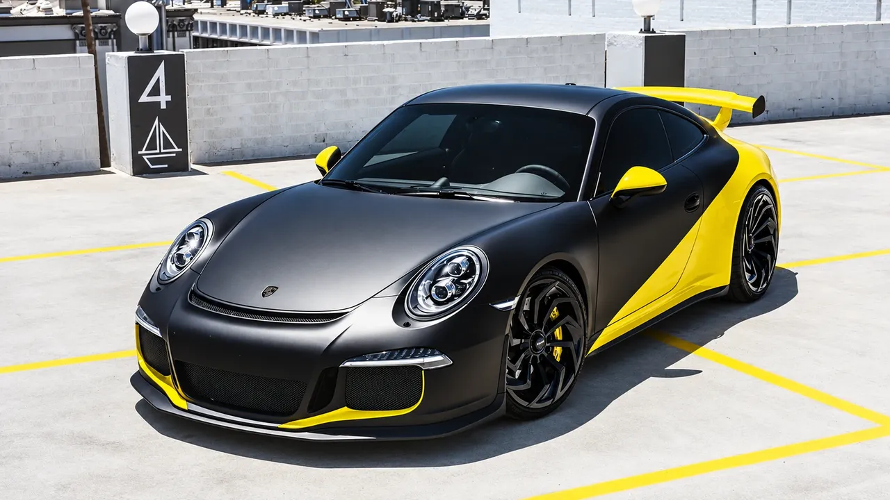 Porsche 911 in a matte black wrap with yellow accents