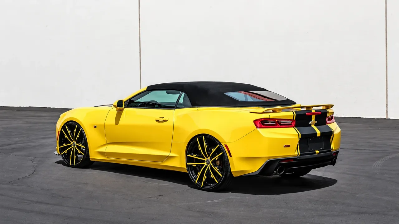 Yellow Chevrolet Camaro convertible with black stripes and matching wheels